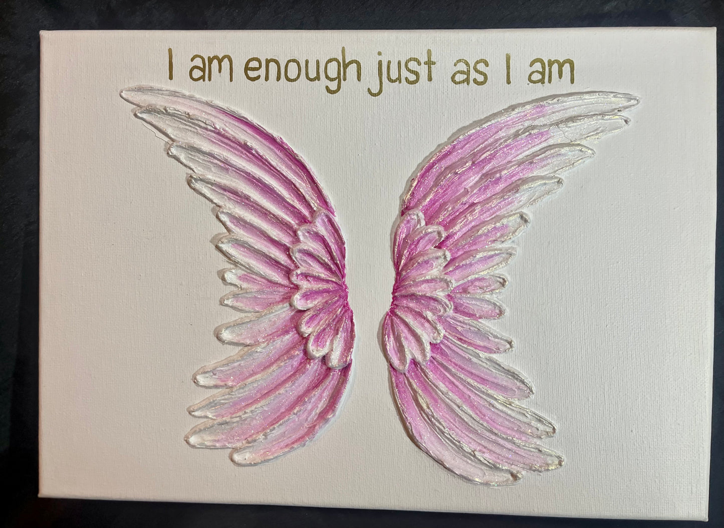 Pink angel wings on a white background with 'I am enough just as I am' text.