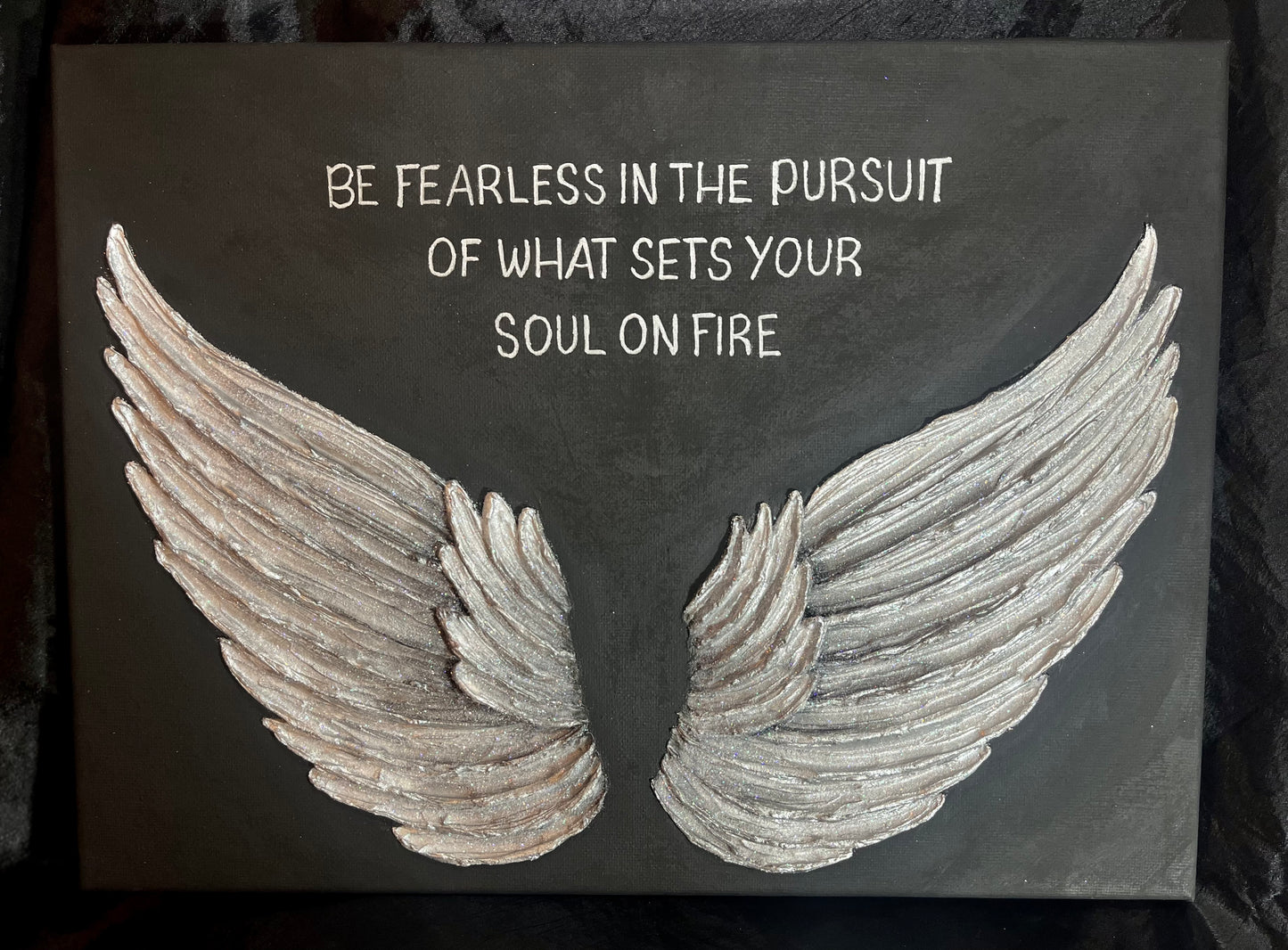 Silver Wings illustration with motivational quote on a dark background