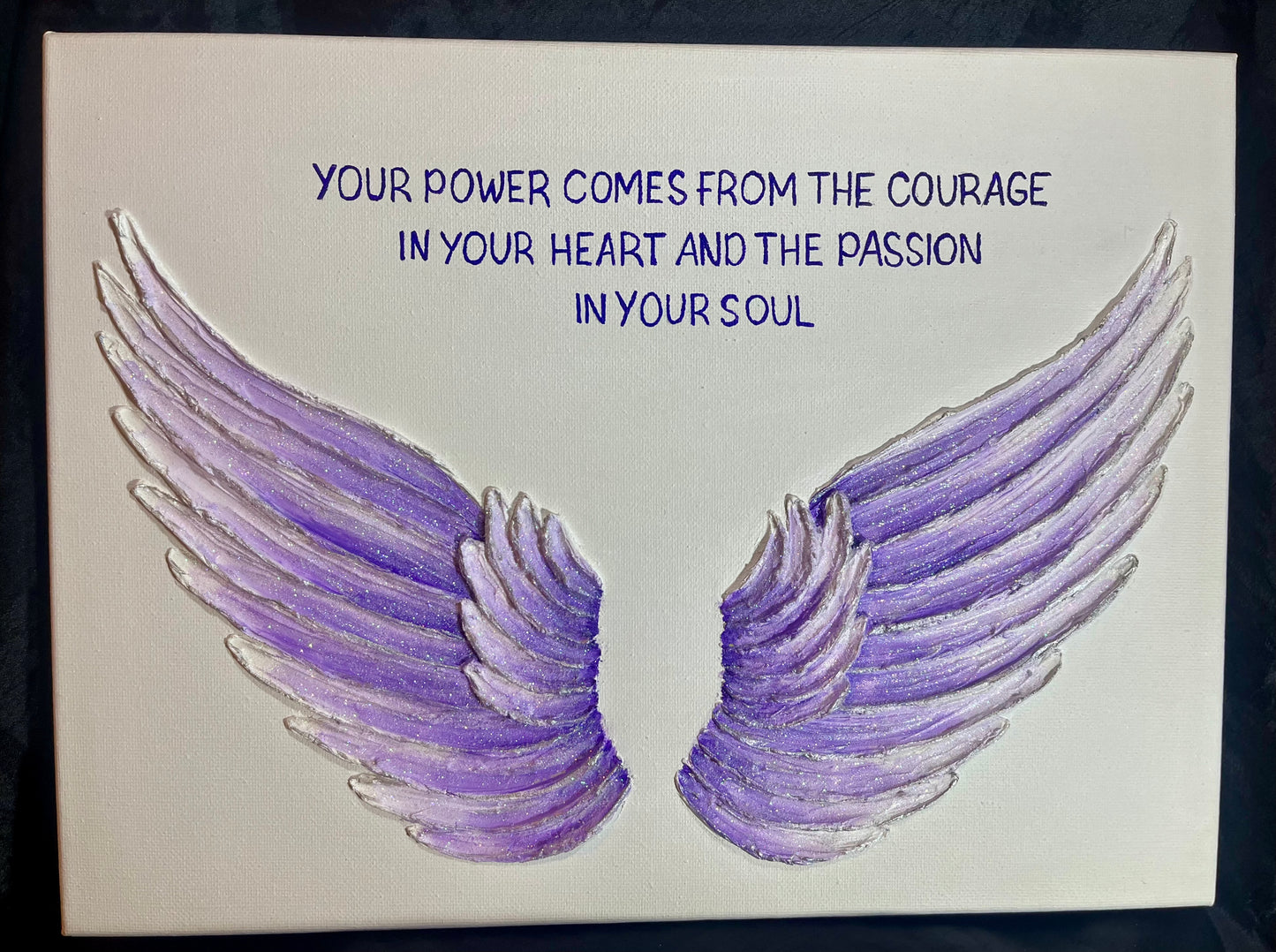 Purple wings on a white background with motivational quote