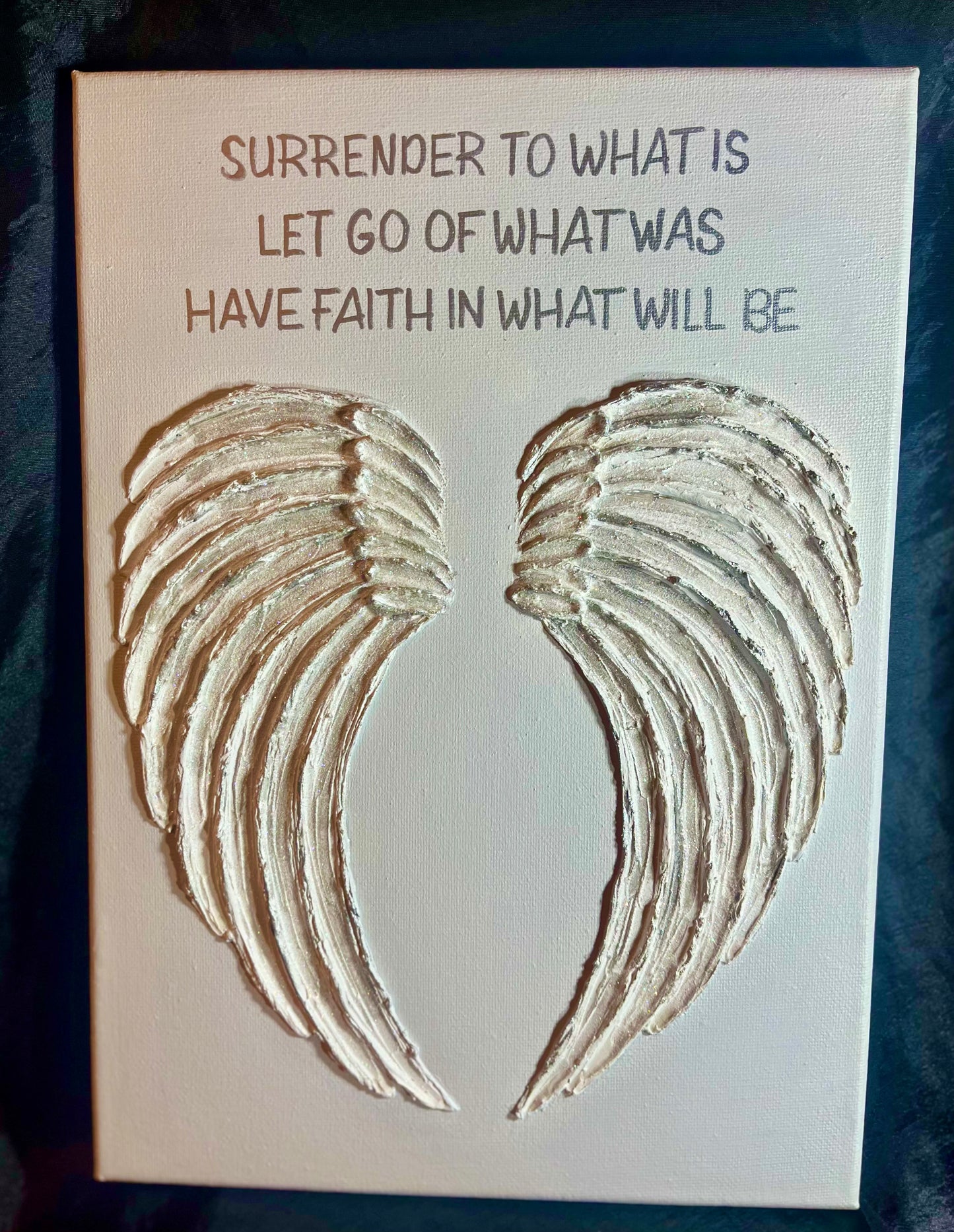 Canvas with light gold  angel wings and motivational quote on a white background