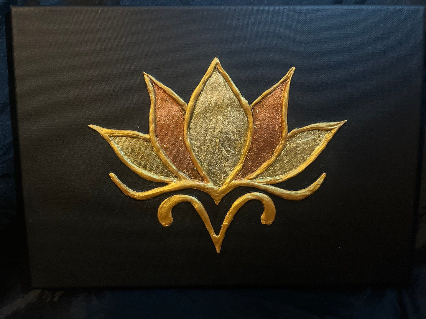 Textured Gold lotus flower design with gold and copper leaf detail on a black background 